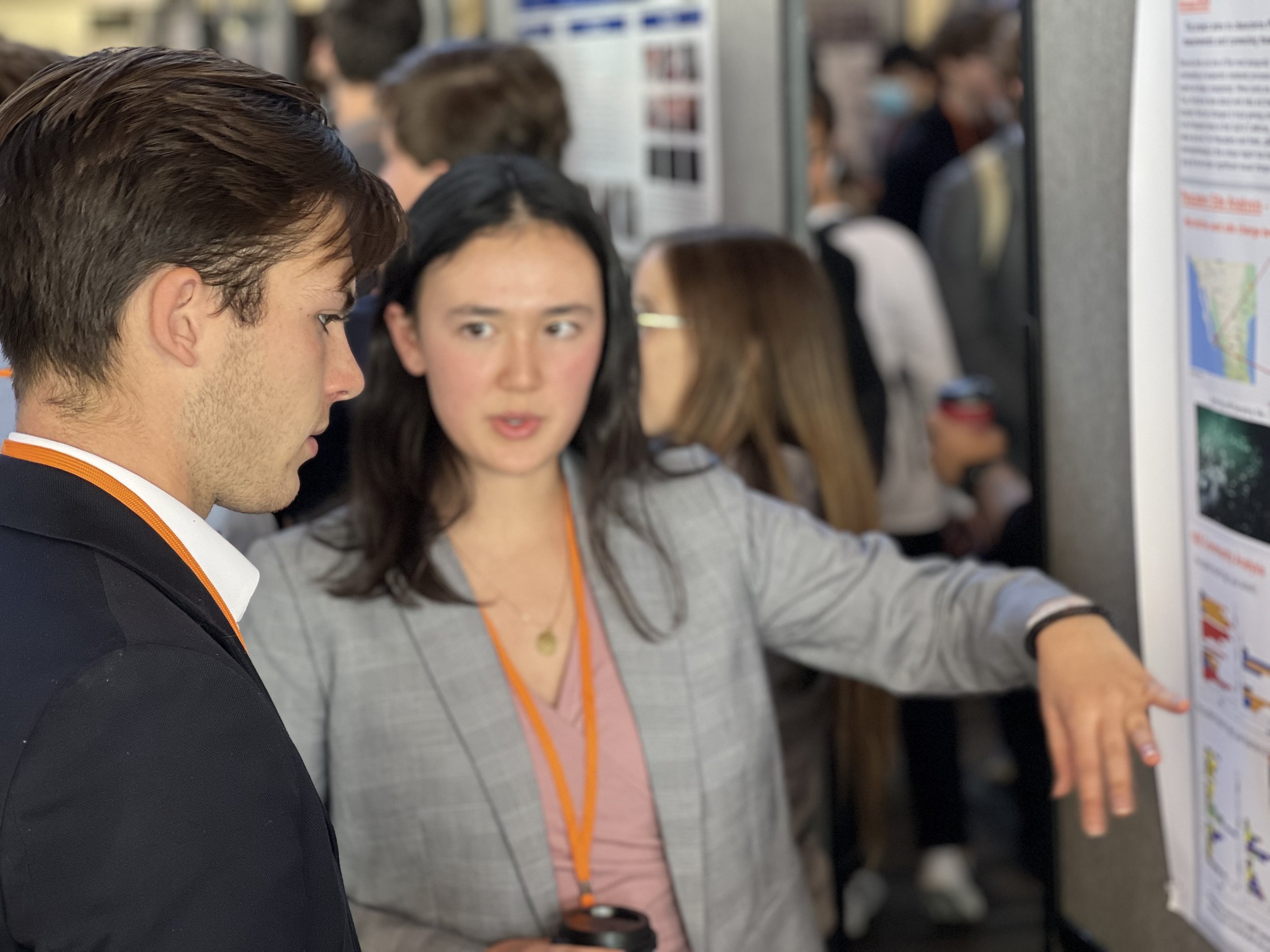 Students discussing research poster