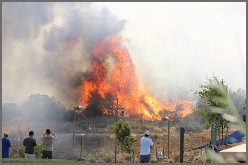 Wildfire Image: People watching a wildfire in the distance.