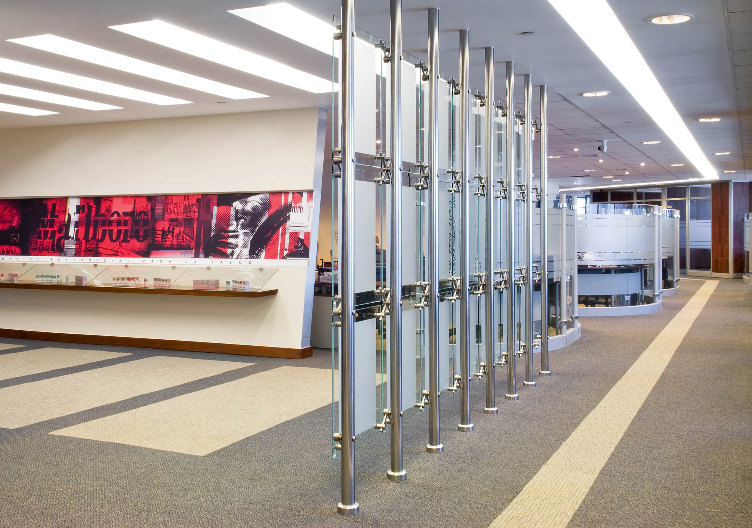 Modern office interior with glass partitions and a colorful wall mural.